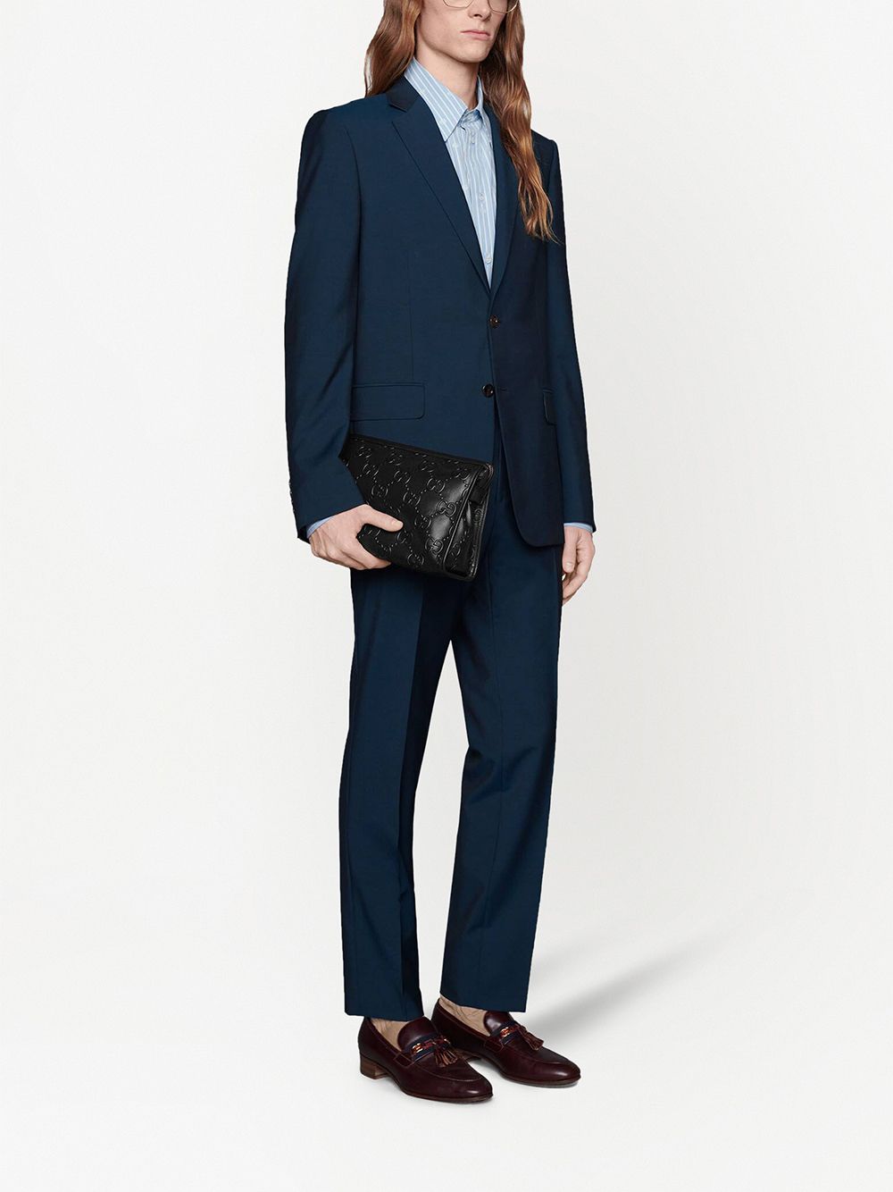 G*u*i gg-embossed clutch bag